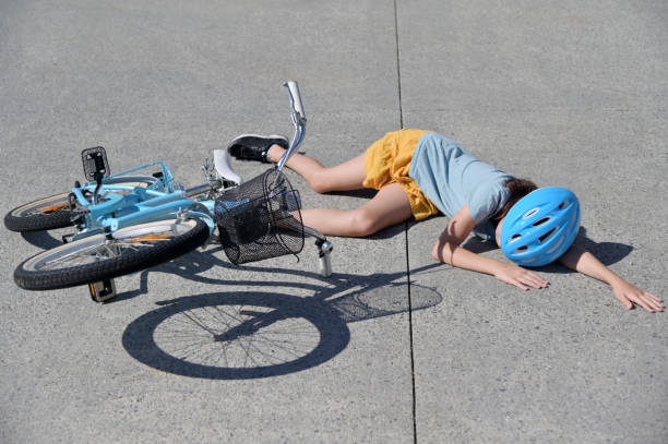 istock Young girl fallen of a bicycle laying down 1314458655