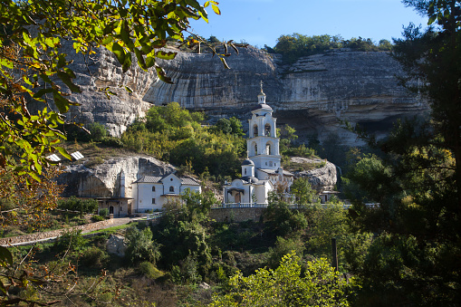 View of the bell tower of the Holy Dormition Monastery in the Crimea, in Bakhchisarai in summer.