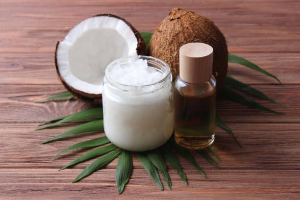 istock coconut oil and coconuts, palm branches close up 1314461728
