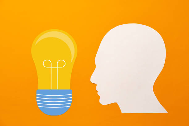 istock Papercut head and light bulb on paper background 1314462394