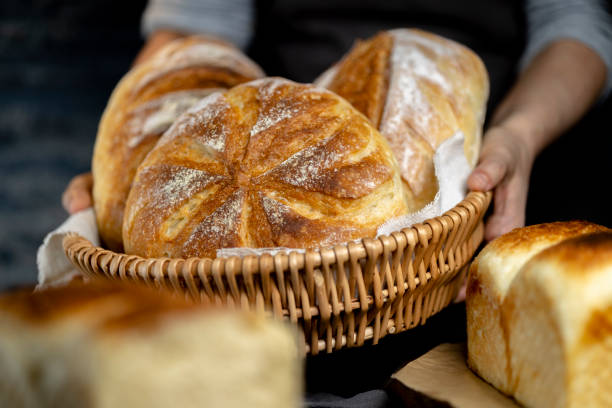 istock baker holding various homemade country breads, ready for pary 1314462458