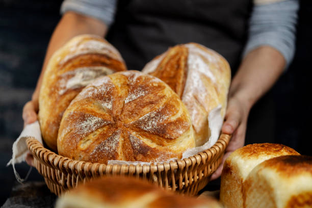 istock baker holding various homemade country breads, ready for pary 1314463019