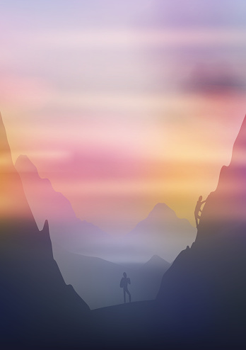 Dawn above mountains, climbers on the cliffside
