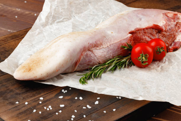 istock Raw beef tongue on dark wooden board 1314464914
