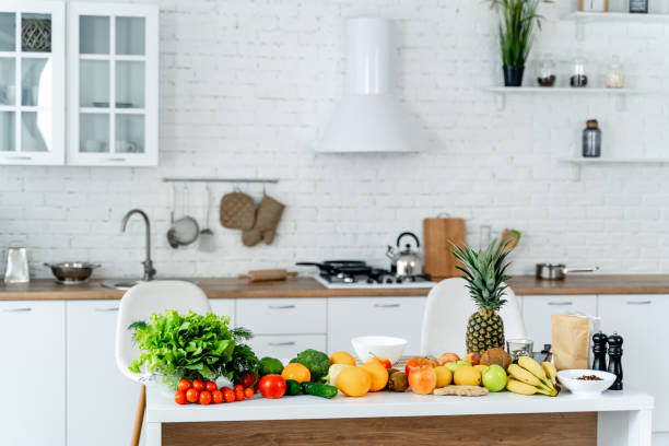 istock Different organic fruits and vegetables on moderm white colored kitchen. Healthy nutrition. 1314465629