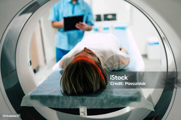 Young Woman Patient Is Ready To Do Magnetic Resonance Imaging In The Modern Hospital Laboratory Stock Photo - Download Image Now