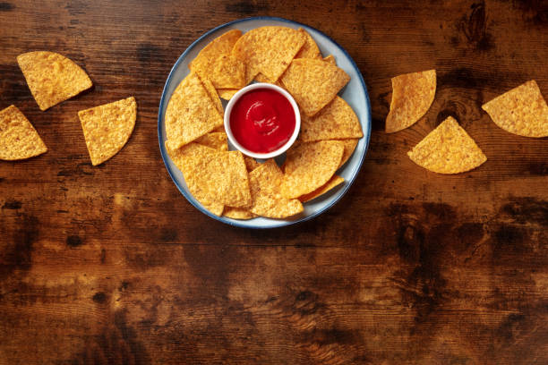 istock Nachos with a dip, shot from above on a rustic wooden background 1314465727