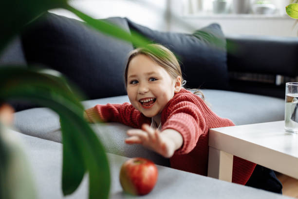 istock Child catching apple to have healthy breakfast 1314467275