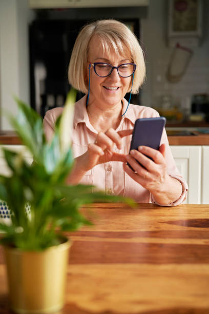 istock Senior woman scrolling on the phone at home 1314468711