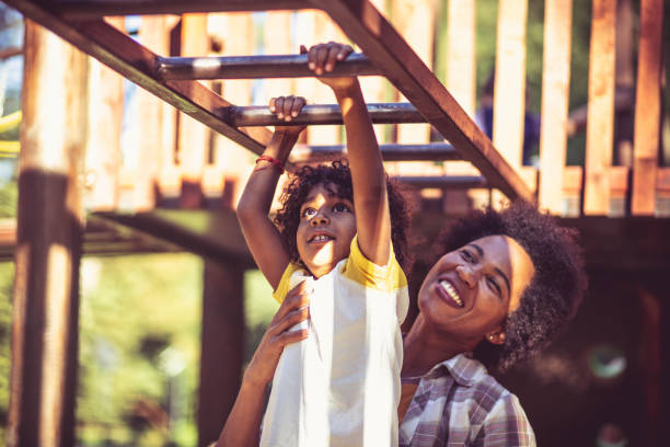 istock Mother and daughter playing on playground. 1314469590