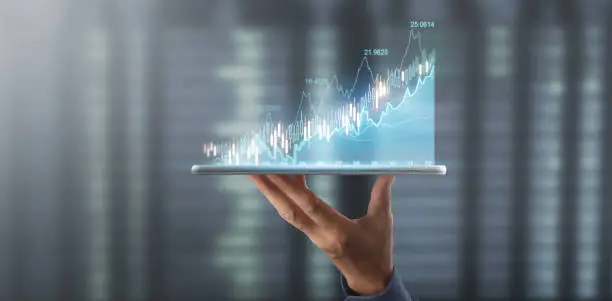 Businessman plan graph growth and increase of chart positive indicators in his business, tablet in hand