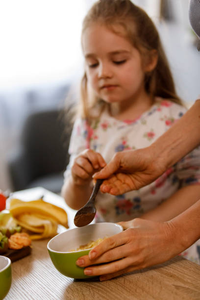 istock Adding a spoonful of cinnamon in a bowl with mashed banana 1314470858