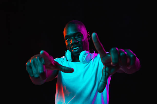 istock Young African-American man isolated on dark background in neon light 1314471246