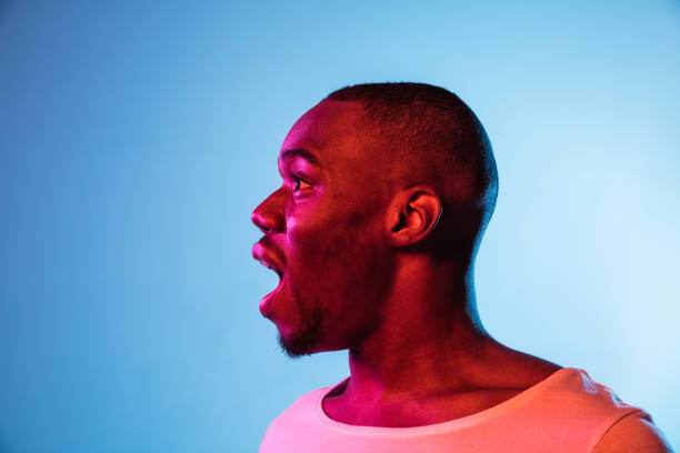 istock One young African man isolated on gradient background in neon light 1314471254