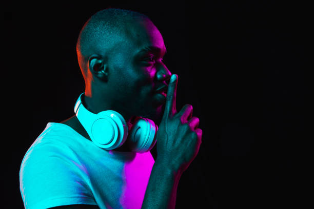 istock Young African-American man isolated on dark background in neon light 1314471256