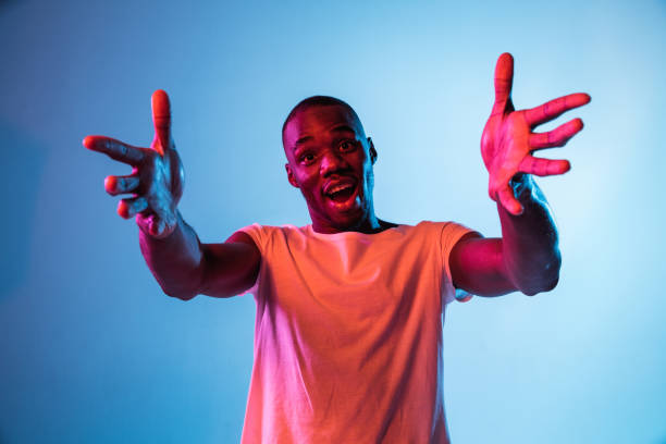 istock One young African-American man isolated on gradient background in neon light 1314471257