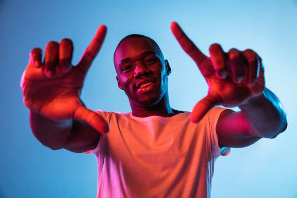 istock One young African-American man isolated on gradient background in neon light 1314471258