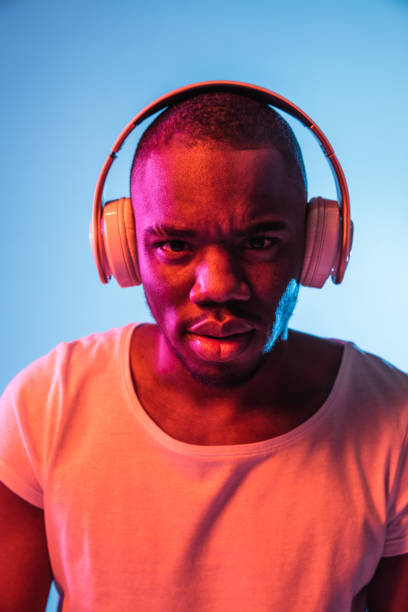 istock Close-up young African man isolated over blue background in neon light 1314471265