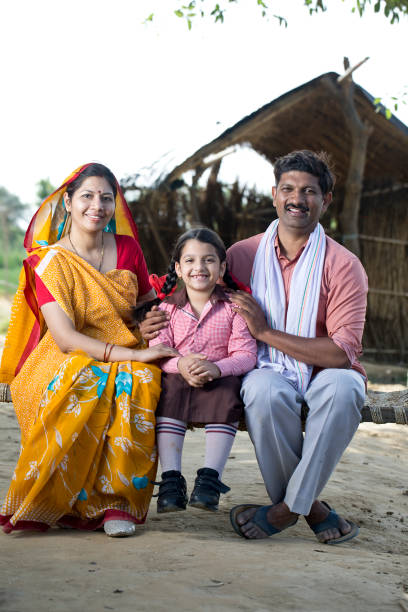istock Indian family sitting on traditional bed 1314471989