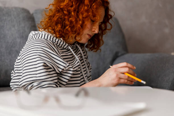 istock Young woman working on her homework and contemplating 1314472430