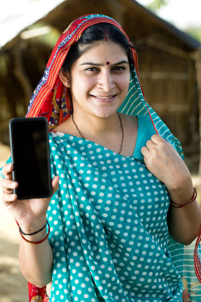 istock Indian woman showing mobile phone 1314472604