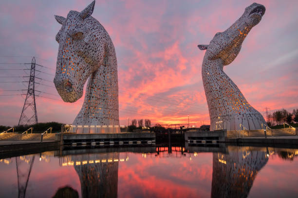 Falkirk, Scotland – April 23, 2021: Opened in 2013, the 30 meter high stainless steel Kelpies made by scuptor Andy Scott, have offered visitors spectacular views of the massive sculptures, often backed by colourful and vibrant sunsets