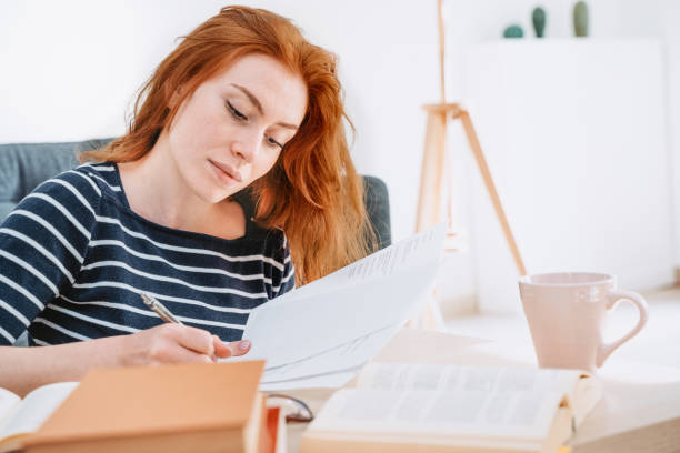 istock Young woman studying at home and doing homework 1314473658