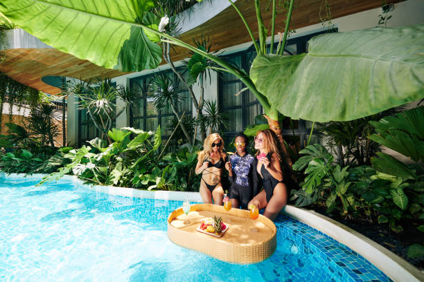 istock Female friends relaxing by pool 1314474413