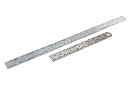Two stainless steel measuring rulers with standard scales in millimeters and inches on a white background