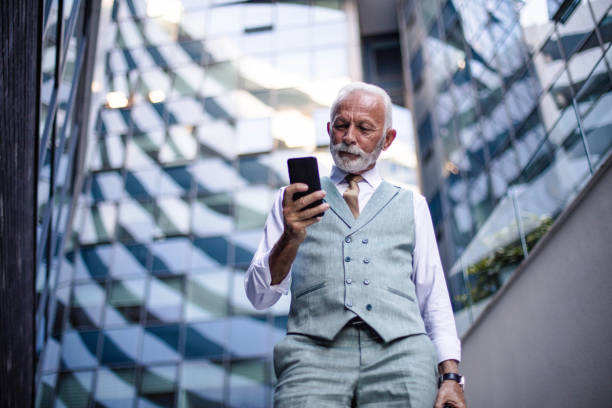 istock Senior business man reading message on phone. 1314476127