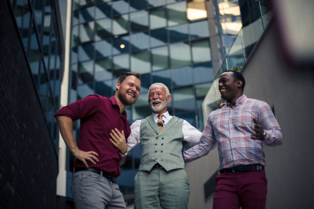 Three happy businessmen walking down the street and communicating.