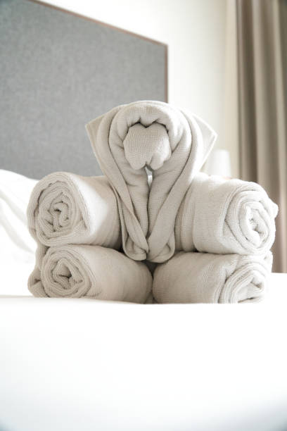 istock Five white towels arranged like dolls on the bed 1314476302