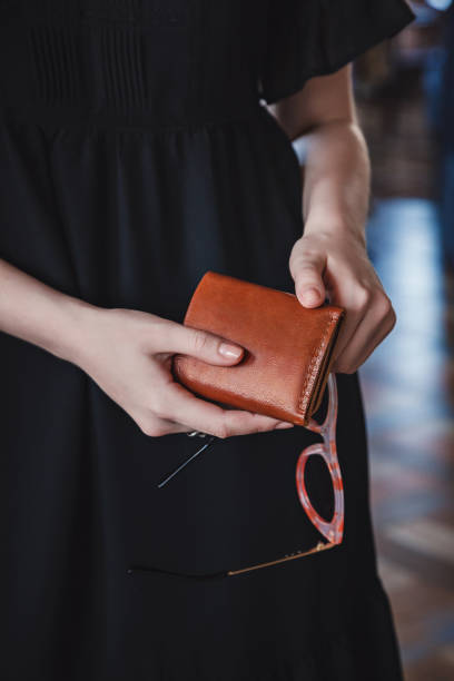 istock The woman is holding a brown leather wallet 1314476803