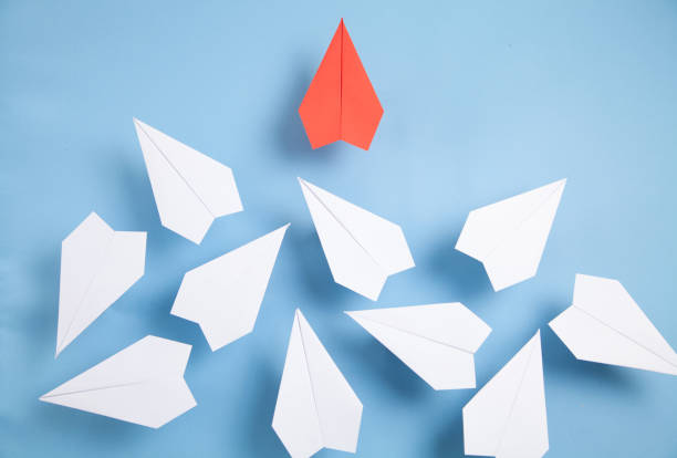 istock Red and white paper airplanes on blue background. Leadership. Teamwork 1314481039