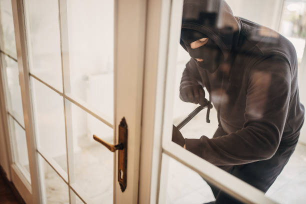 istock Criminal trying to brake in house 1314481612