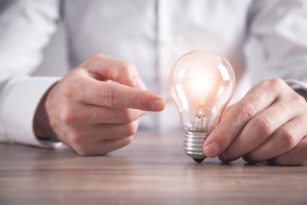 istock Man holding light bulb. Concept of inspiration and creativity 1314481673