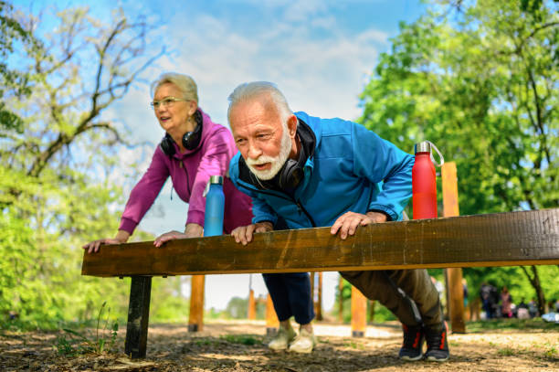 istock Senior couple stretching after jogging in a public park. 1314481796