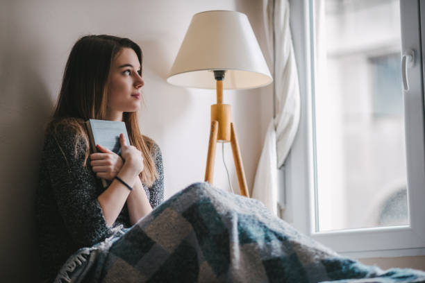 istock Woman holding a book 1314482359