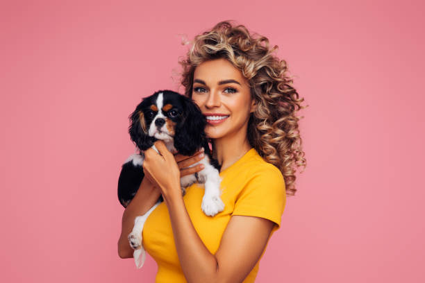 istock Studio Portrait Of Smiling Young Woman Holding Affectionate Pet 1314485553