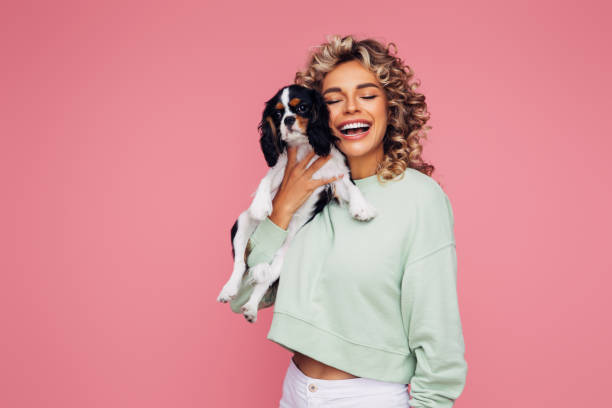 istock Studio Portrait Of Smiling Young Woman Holding Affectionate Pet 1314485593