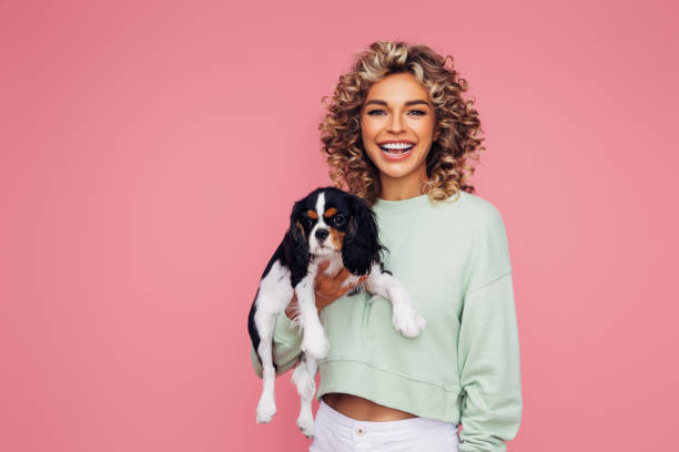 istock Studio Portrait Of Smiling Young Woman Holding Affectionate Pet 1314485621