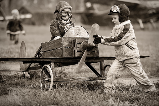 Young aviators at the airport with a homemade airplane