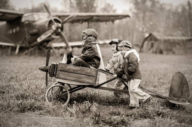 Young pilots Young aviators at the airport with a homemade airplane vintage aviator pictures stock pictures, royalty-free photos & images