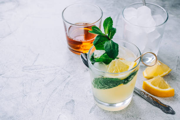 istock Ice lemonade in glass with lemon pieces, fresh mint and ice cubes. 1314487879