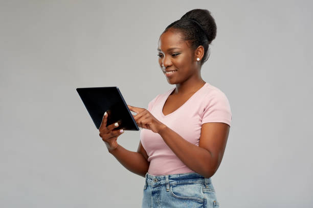 istock happy african american woman using tablet pc 1314487968