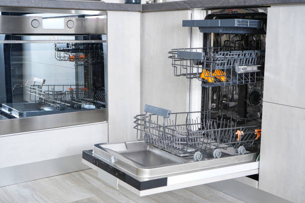 Open, empty dishwasher. Washing dishes in the dishwasher. Open automatic dishwasher. stock photo