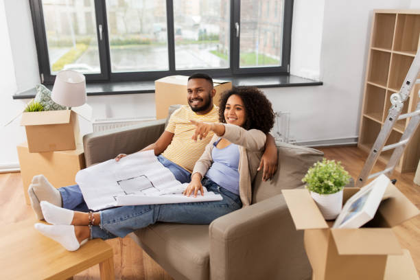 istock couple with boxes and blueprint moving to new home 1314488430