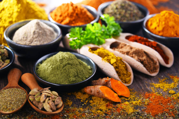 istock Variety of spices on wooden kitchen table. 1314488627