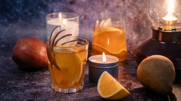istock apple cider with candle light and fruits 1314489385