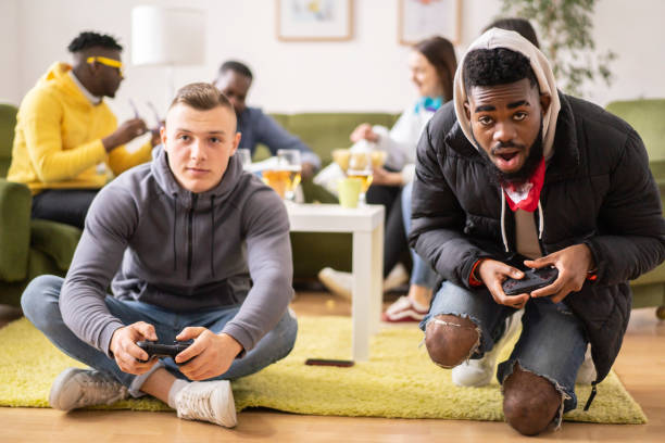 dwóch przyjaciół rywalizujących w grze wideo - friendship video game young adult party zdjęcia i obrazy z banku zdjęć